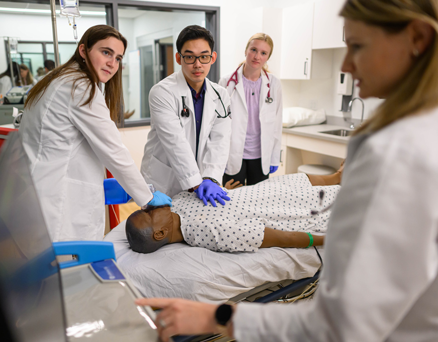 Physician Assistant students working on a manikin in the simulation lab