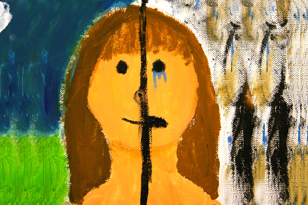 A child's painting of a woman's face where one half is happy and the other half is sad