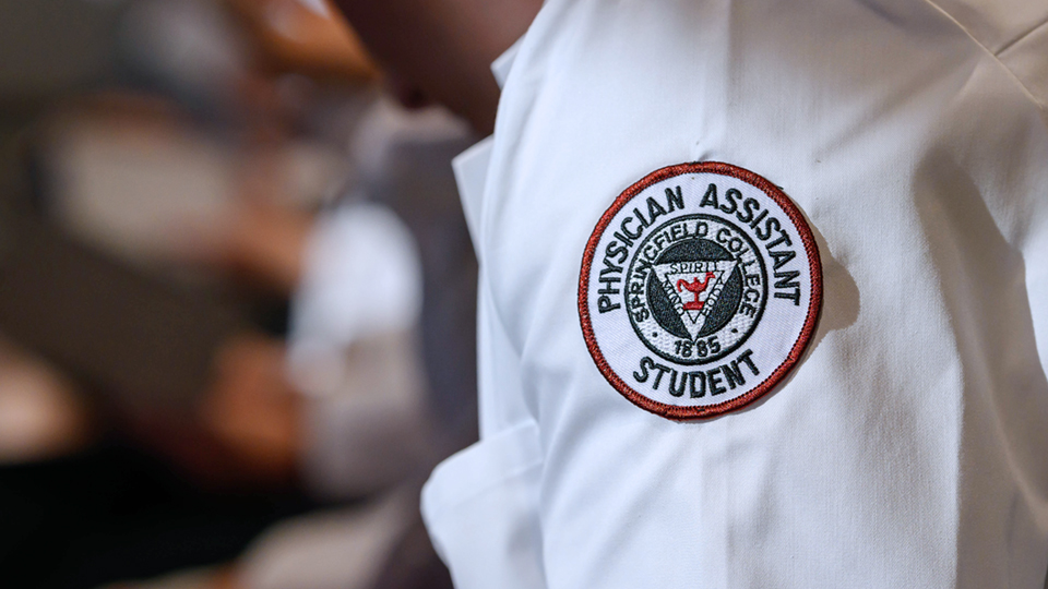 photo showing the seal for Springfield College Physician Assistant students on the sleeve of a white lab coat
