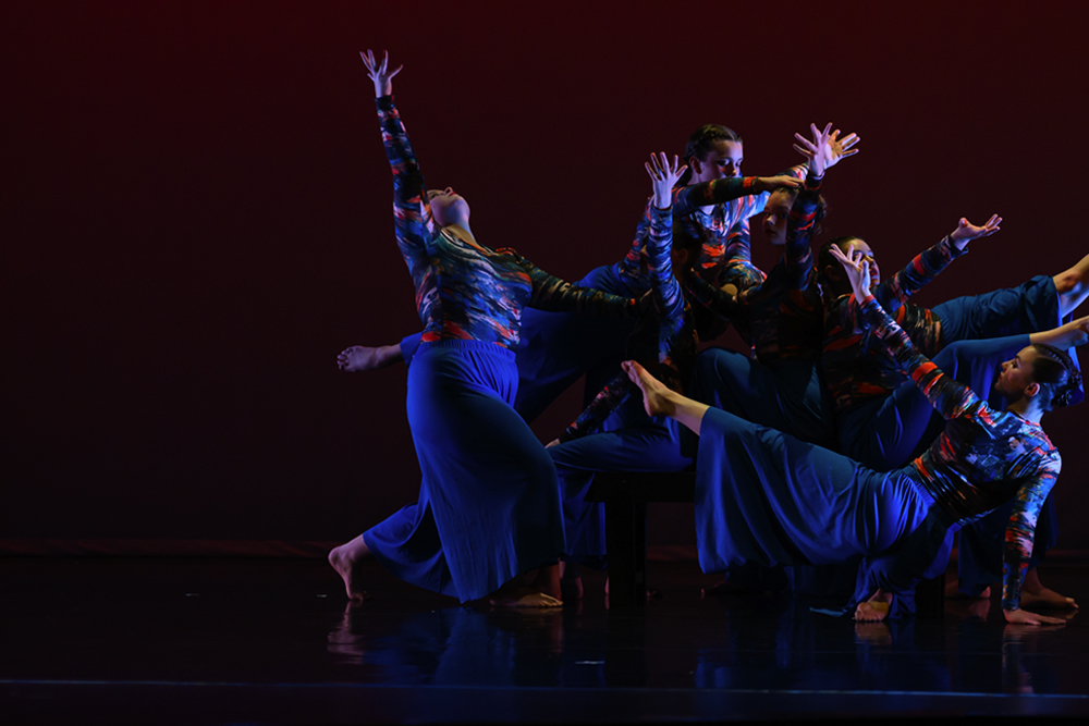 a group of student dancers performing onstage